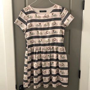 Women’s pink and grey striped dress with bicycles